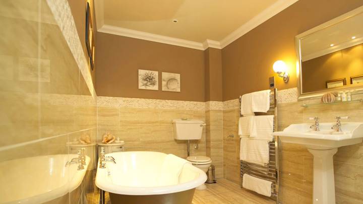 Wooden Color Interior In Bathroom And White Bathtub And Sink